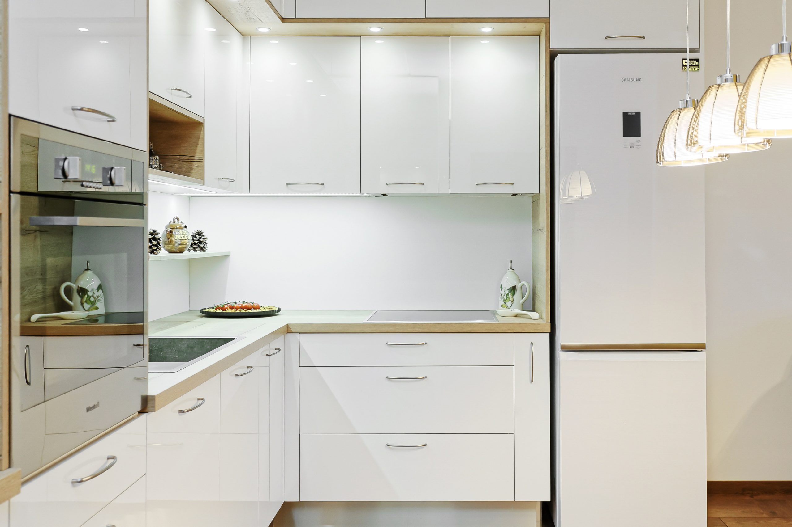 Compact corner kitchen design in light colours