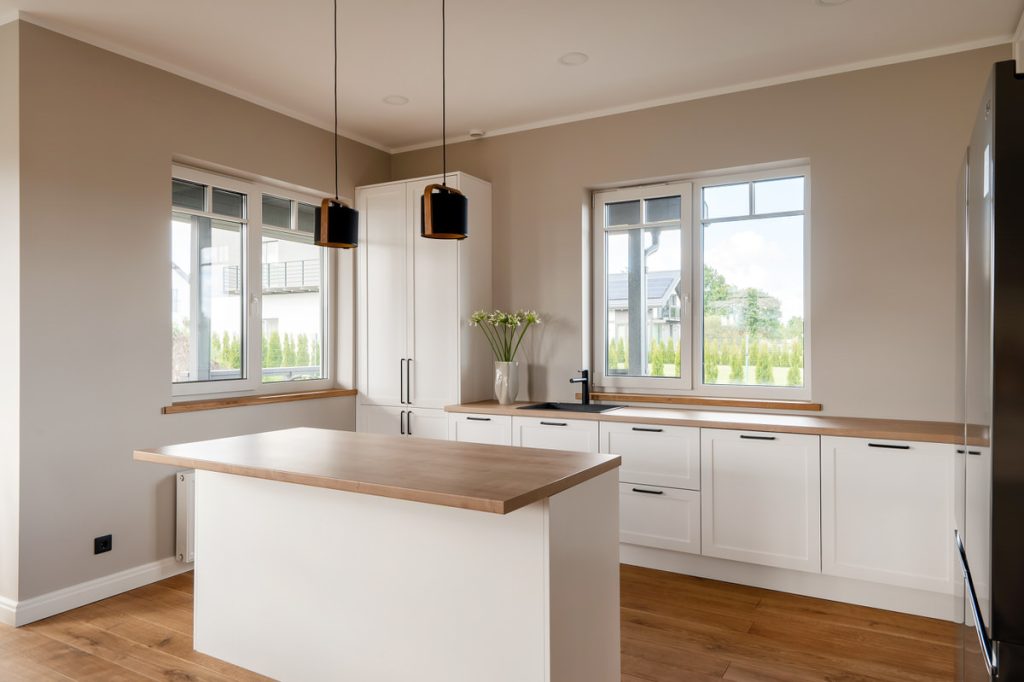 White kitchen with wooden worktop in a bright home